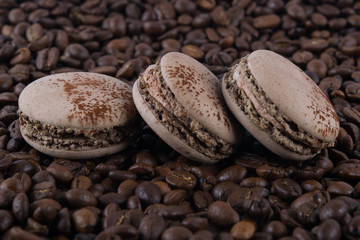 on the background of coffee beans lie chocolate taste cookies,macaron