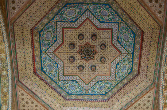 Ornate handcarved wooden ceiling insert at the ancient Bahia Palace in Marrakech, Morocco
