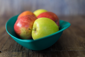 Organic Red and Green apples in a bowl closeup