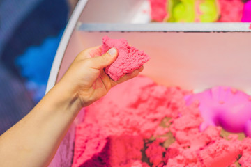 Boy playing with kinetic sand in preschool. The development of fine motor concept. Creativity Game...