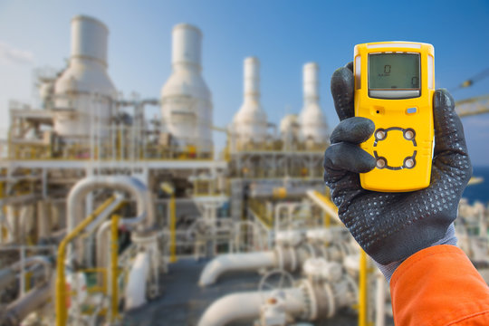 Safety concept of safety and security system on offshore oil and gas processing platform, hand hold gas detector for check hydrocarbon leak to protect fire and explosion.