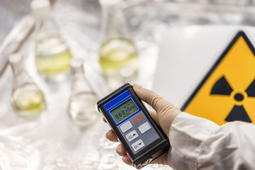 the scientist measures the level of radiation