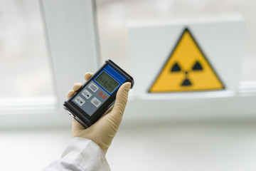 the scientist measures the level of radiation