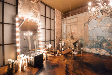 Loft interior with mirror, candles, brick wall, large window, living room, coffee table in modern design