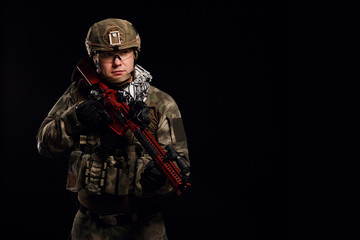 Picture of soldier in helmet with gun on empty black background