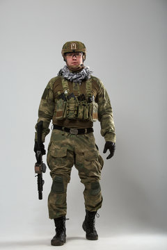 Full-length image of soldier with gun in his hand