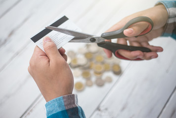 Cuting credit cards with scissors.