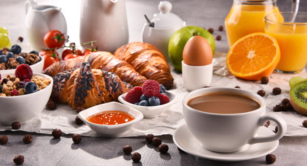 Breakfast served with coffee, juice, croissants and fruits