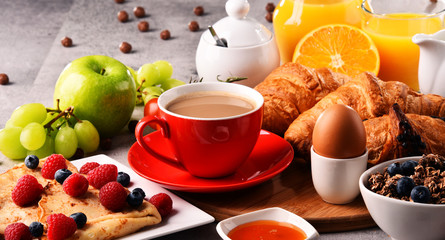 Breakfast served with coffee, juice, croissants and fruits