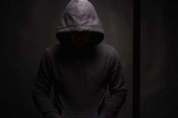Naklejka na ściany i meble Man in dark, figure in a hooded sweatshirt
