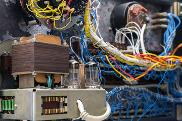 Transformer, radio tubes and wires. Old radio lamp device. Lamp receiver. Inside view. Selective...