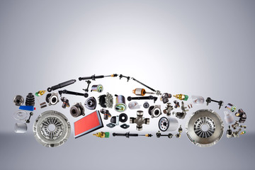 Passenger car assembled from new spare auto parts for shop aftermarket. Isolated on grey background.
