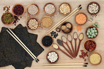 Macrobiotic diet health food concept with nori seaweed, grains, legumes, seeds, wasabi nuts and vegetables with foods high in fibre, smart carbohydrates, antioxidants and minerals. Top view .