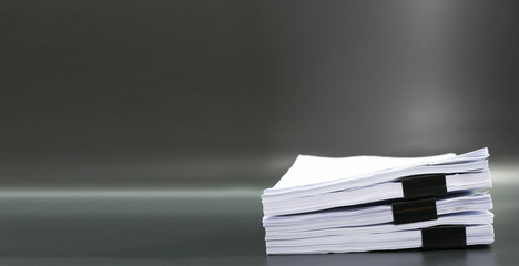 Stack documents or files on black background.
