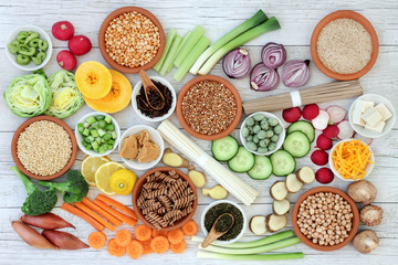 Macrobiotic health food concept with soba and udon noodles, miso, tofu, kuchika tea, wasabi nuts, vegetables, whole wheat pasta, legumes and grains with foods high in protein, antioxidants & vitamins.
