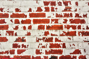 Wall of red bricks with rest of white color for abstract backgrounds.