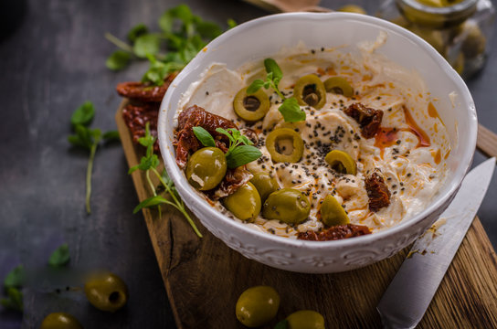 Fresh cheese with olives, dried tomatoes