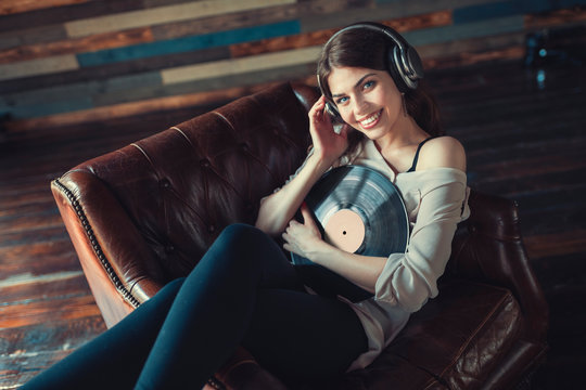 Smiling young girl listening to music