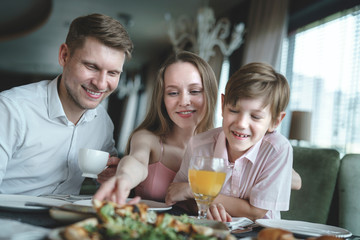 Young family eating pizza