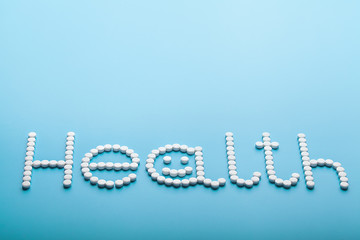 word text is made up of pills, health concept