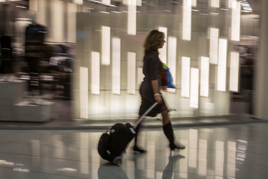 Business woman rushing at the airport in the morning  with motion blur effect - 12