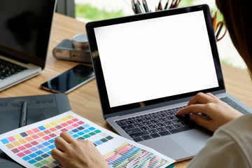 Working woman using laptop computer with empty screen.