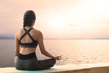 Fototapeta na wymiar Meditating Woman practices yoga relax in nature