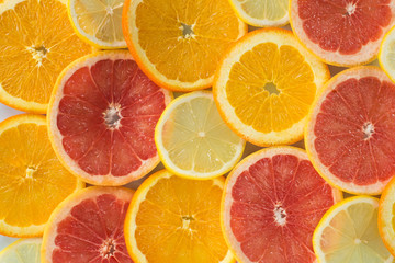 Fototapeta na wymiar Grapefruit, orange and lemon thinly sliced