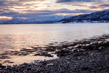 Sunset in the sea and mountain in horizon