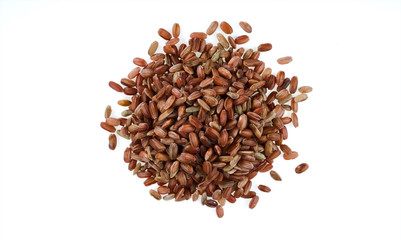 Handful of brown unpeeled rice isolated on white background. One of the varieties of rice.