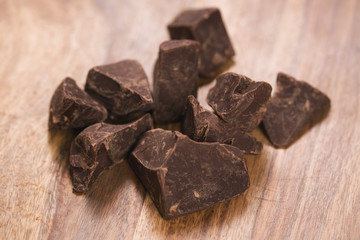dark chocolate chunks on wood table