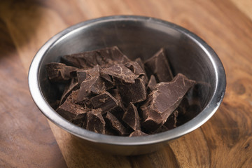 dark chocolate chunks in steel bowl on table