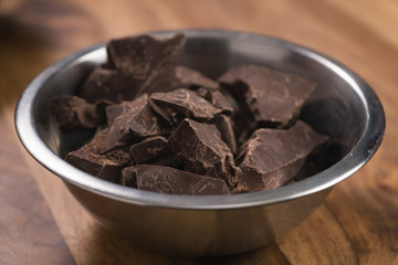 dark chocolate chunks in steel bowl on table