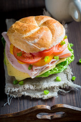 Delicious sandwich with vegetables and ham in the morning