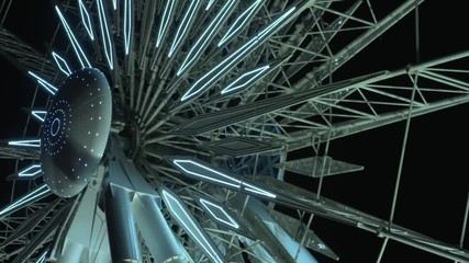 Ferris wheel rotates slowly at night
