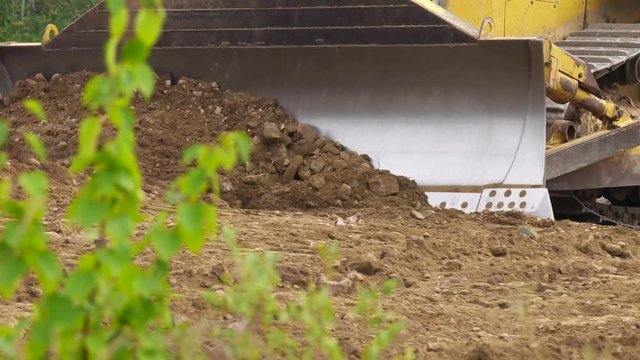 Bulldozer pushing dirt.
