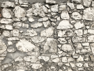 Rusty texture of old white stone wall. Detail and decoration.