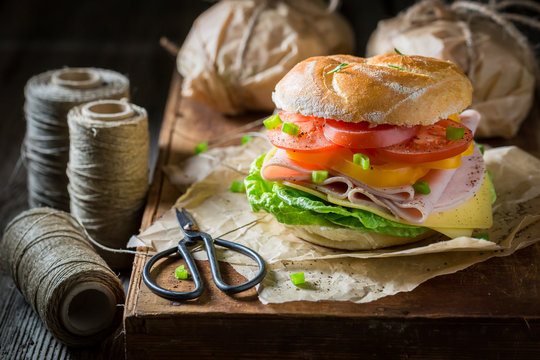 Delicious take away sandwich packed in a gray paper