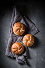 Tasty golden rolls on rustic linen napkin