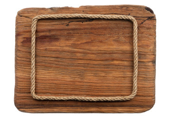 Frame made of rope lies on an old wooden board. Isolated
