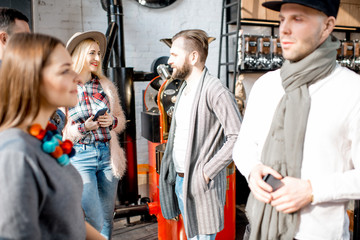 Young friends dressed casually have fun spending time in the beautiful cafe