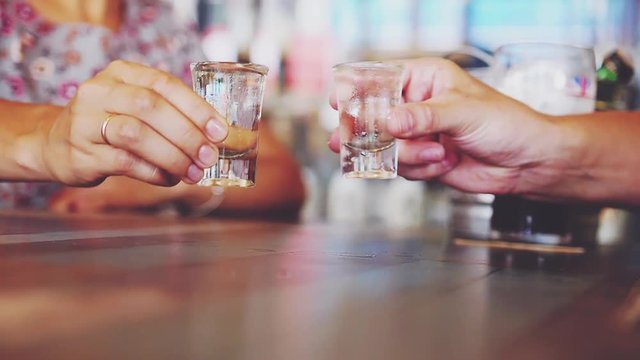 Couple clink with glasses of sake in japanese cafe. slow motion. 3840x2160