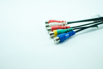 Five colorful wires, blue, red, green, and white, on a white background