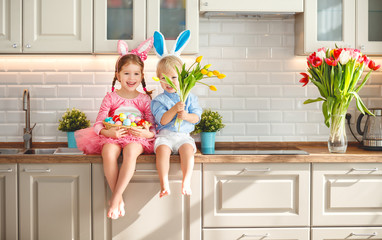 Happy easter! funny funny children  l with ears hare getting ready for  holiday