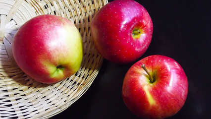 Red apples in the basket.