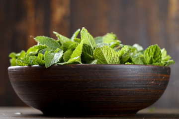 Green fresh mint om the wooden table