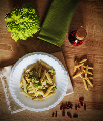 Fototapeta premium Pasta and roman cauliflower on a wooden table