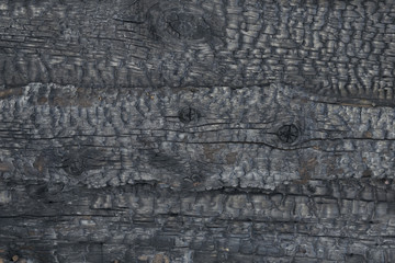 Wooden texture close-up. A dark old tree. Burnt wood. Vertical stripes.