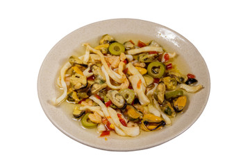Seafood salad with shrimp, squid and mussels isolated on white background