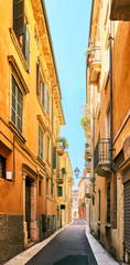 Fototapeta na wymiar VERONA, ITALY - AUGUST 17, 2017: Narrow street of Verona high vibrant building facades.